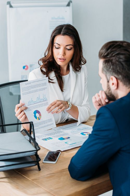 Image of businesswoman and businessman looking at graph, shown on Factored Annuities - A Wise Investment page.